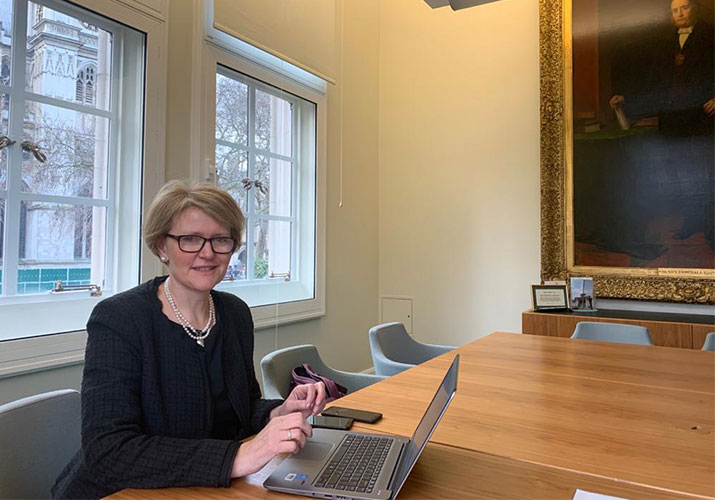 A photo of senior associate Anne Kavanagh working at a desk in the Supreme Court
